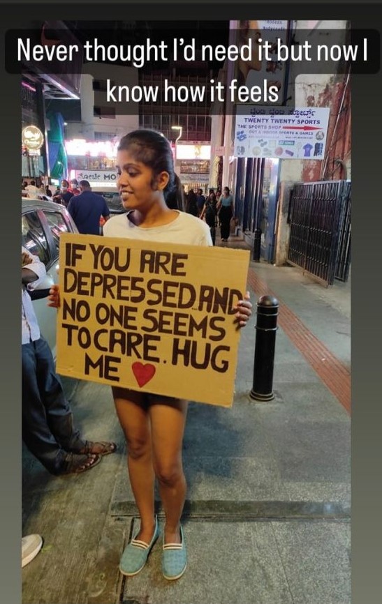 Girl offering free hugs for those who feel lonely and depressed